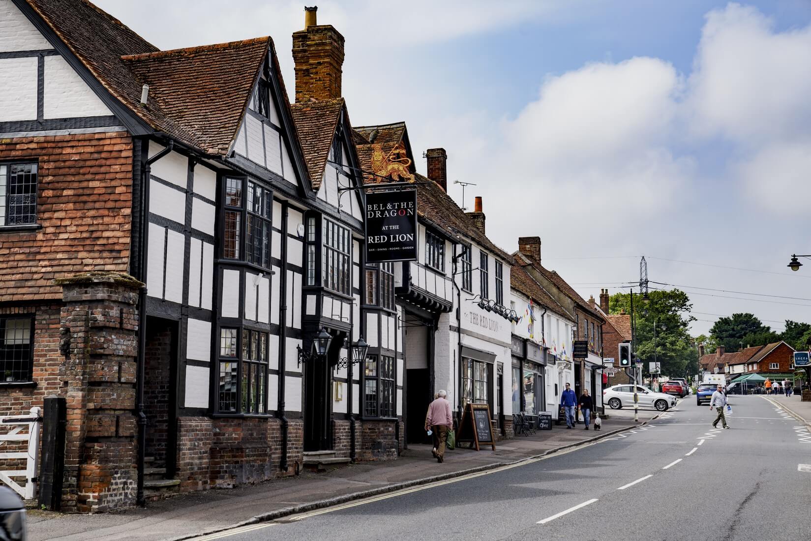 Timber-framed buildings and a hanging pub sign on Wendover High Street.